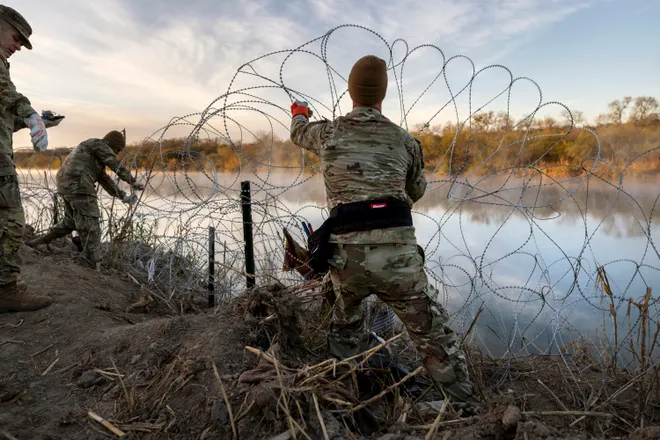 Texas National Guard soldiers installing razor wire along the Rio Grande on January 10, 2024 in Eagle Pass, Texas. 