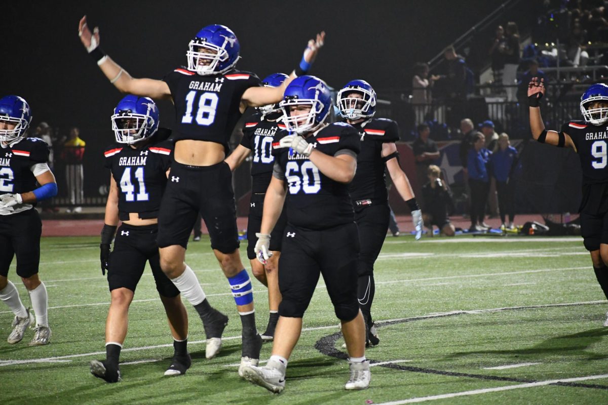 Players jump into the air in celebration. 