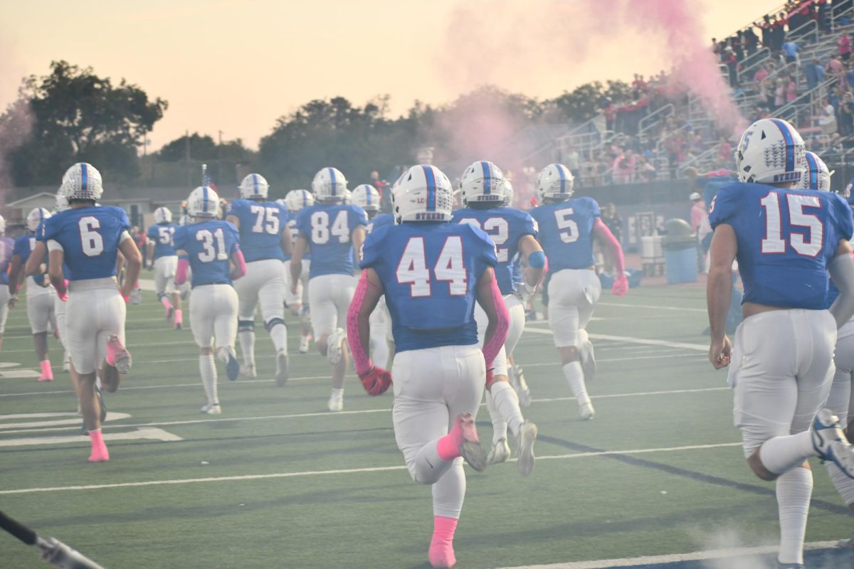 Players run down the field. 